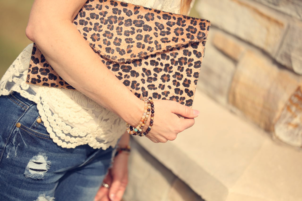 Leopard clutch and embroidered lace shirt